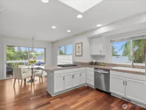 This light-filled kitchen combines style and function with stainless steel appliances and a newly installed KitchenAid 4-burner gas stove.