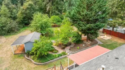 Nicely landscaped rear yard with water feature and 2 outbuildings with electricity.  The remainder of the 1+acre is a greenbelt area, home to some amazing wildlife:  deer, pheasants,etc.