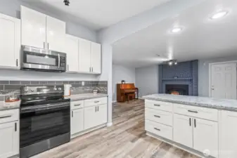 Newer gourmet kitchen with family room and eating bar.