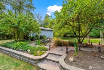 Beautifully landscaped back yard with waterfeature