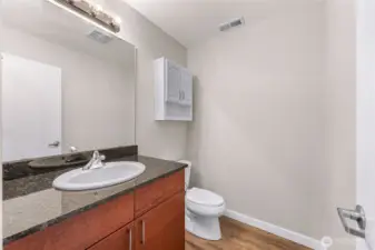 Convenient main level powder room with ample storage and a clean, modern feel.