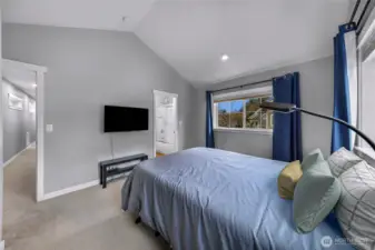 Another view of the primary suite showing the natural light and easy flow to the attached bathroom.