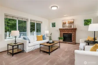 Spacious family room with a cozy brick fireplace and views of the private backyard. With greenbelt on two sides, this room offers both comfort and seclusion.