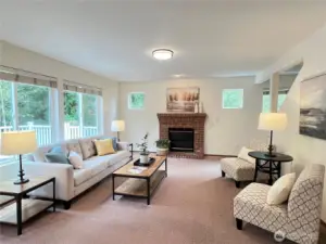 Family room looking straight-on towards the gas fireplace. Notice how wide this room is. Stairs to the upper level are on the right.