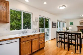 The kitchen, eating area, and family room overlook the oversized deck and greenbelt. The slider provides easy access to the deck or entertaining, while abundant windows bring in sunshine and offer privacy.