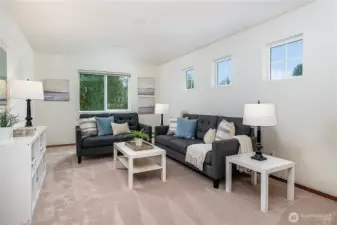 Large bonus room upstairs offers flexible space to watch TV, relax, or work.