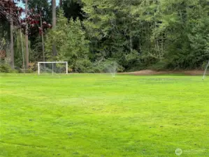 Soccer field nearby, with trails behind it that wind throughout the Silver Firs community.