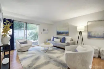 The living room is spacious and light-filled, with the newer vinyl-plank flooring throughout.  There's an additional closet to the left, plus numerous ways to position your furniture.