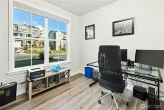 A bright office just off the front door offers a convenient and flexible workspace filled with natural light. Ideal for working from home or meeting clients, this room provides both privacy and functionality.