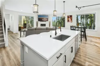 Updated flooring and modern appliances elevate the open-concept kitchen, creating a clean, contemporary look that flows seamlessly into the living and dining areas. Sleek finishes and thoughtful upgrades make this space as functional as it is beautiful.