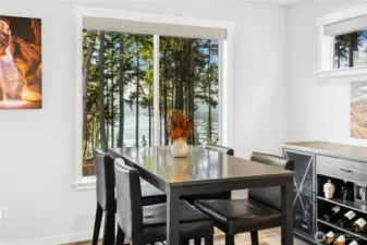 The dining area is perfectly positioned to take in stunning views of Liberty Bay, creating a beautiful backdrop for everyday meals and special gatherings. Natural light and serene surroundings make this space both inviting and memorable.