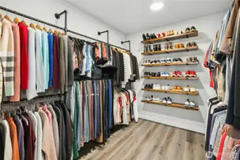 The primary walk-in closet is thoughtfully updated with custom hanging space, open shelving, and dedicated shoe storage. Spacious and well organized, it offers both style and functionality for everyday living.