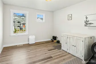 This bedroom is bright, clean, and flexible. Neutral finishes, durable flooring, and two windows bring in great natural light while keeping the space calm and versatile for a variety of uses.