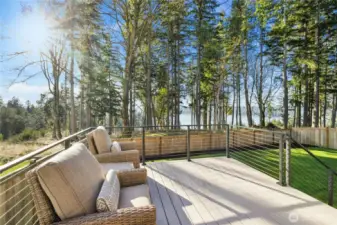 The main-level deck is a true retreat—perfect for morning coffee or evening gatherings—overlooking a lush, tree-lined backdrop with filtered water views beyond. Designed for easy entertaining and everyday relaxation, this spacious deck extends your living space outdoors and offers a peaceful, private setting surrounded by nature.