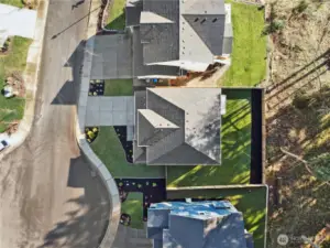 This straight-down aerial view clearly shows the home’s generous lot and thoughtful layout. The fully fenced backyard backs creating a rare sense of space and privacy within the neighborhood. With a wide driveway, clean lot lines, and no rear neighbors beyond the trees, the property enjoys both functionality and a peaceful buffer—an ideal combination for outdoor living, pets, and long-term privacy.