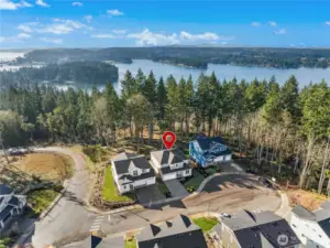 This aerial view captures the home’s exceptional location—set at the end of a quiet cul-de-sac with sweeping views of the water beyond. The pin highlights a rare combination of privacy and scenery, where natural surroundings frame the neighborhood and create a true Pacific Northwest setting. Just moments from trails and shoreline, this is a home that feels connected to nature while remaining close to everything you need.