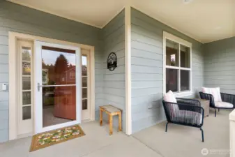 This welcoming entry features a cozy sitting area and a handy storm door to let in so much natural light!