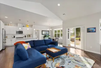 The open plan living area features high ceilings, fresh designer paint colors and enormous windows for plenty of natural light.