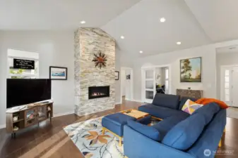 This handcrafted floor-to-ceiling, stone wrapped fireplace with gas insert is the heart of the home! French doors lead to the handy office/den.