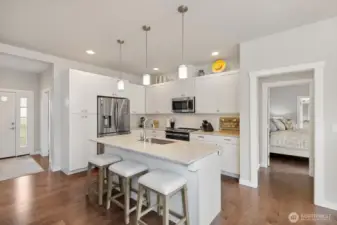Enjoy this light-filled and roomy chef's kitchen, with tons of cabinetry, high-end stainless appliances, and natural light.