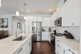 So much space to gather and entertain! High-end cottage-style cabinetry and subway tiled backsplash provides timeless beauty.