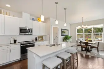 The open kitchen space offers several dining options, all taking in the woodland views.