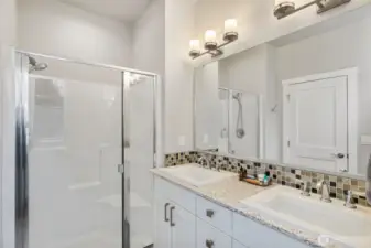 Pamper yourself with beautiful custom tile, quartz counter and ample cabinet storage!