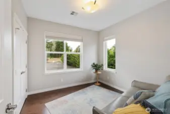 The second bedroom features a roomy closet with built-ins, and huge windows looking into the back yard and the view beyond.