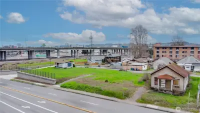 Former home on right no longer of value. Buildings behind as well are boarded up
