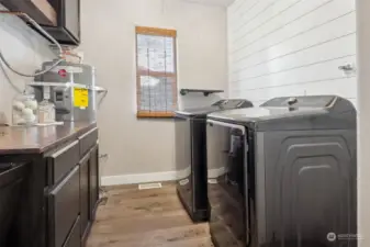 Laundry room with additional storage and utility sink