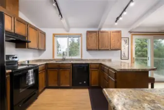 View of upper level kitchen from the top of the stairs