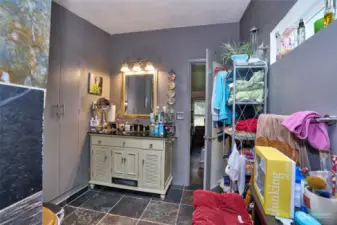 Primary Bathroom with updated vanity and slate tile flooring.