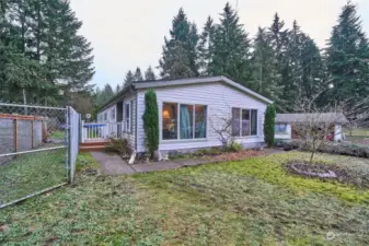 Front end of house with big windows.