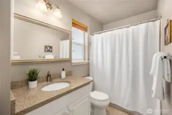 The bedroom includes a full ensuite bathroom with updated quartz countertops