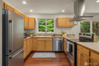 All stainless appliances and range hood. Great view from the sink onto the deck and fully forested backyard.