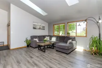 Living room with large windows to let in lots of natural light.
