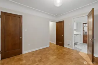 Looking towards hallway and kitchen from bedroom. Bedroom closet on left.