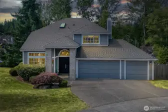 This stately Summerwind home offers timeless curb appeal with a grand entry, brick accents, and a three-car garage