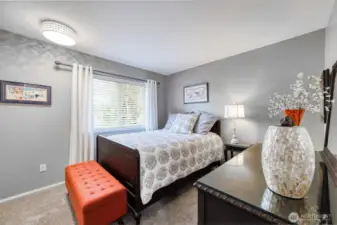 Upper-floor guest bedroom offers plush carpeting, soft natural light, and a calm, comfortable retreat