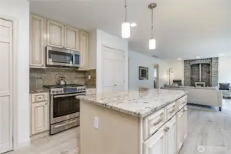 Center island offers great food prep space and extra storage. Gas range is flanked by 2 large pantry closets!
