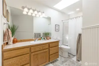 Full upstairs hall bath with bright skylight