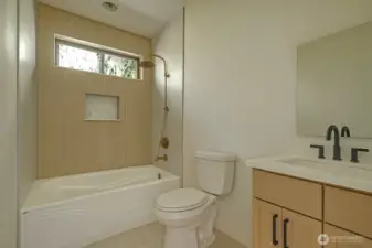Clean and functional design with tiled tub/shower combo.