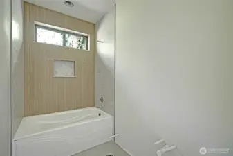 Clean and functional design with tiled tub/shower combo.