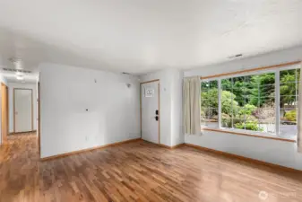 Expansive windows invite ample natural sunlight creating warm, inviting, light-filled interiors