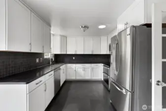 Kitchen includes a skylight with an integrated fan, allowing sun-drenched cooking space and optimal airflow for comfort and style