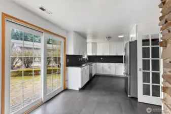 French doors enhance the kitchen entrance, providing a touch of Sophistication and seamless access to the heart of the home