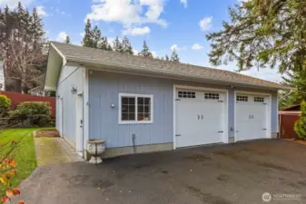 Detached two-car garage at the back of property, perfect for secure vehicle parking, additional storage and workshop space