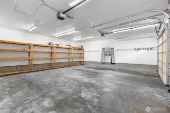 Detached garage interior equipped with built-in shelving, ideal for keeping tools, equipment, and belongings neatly organized with maximizing functional space