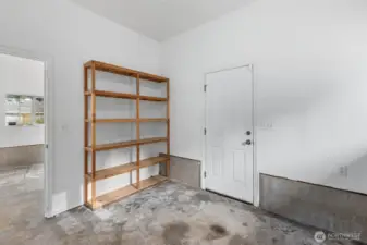 Spacious garage featuring extra built-in shelving, perfect for tools, seasonal items and efficient home organization