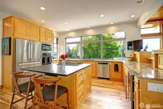 Kitchen with new center island granite and Thermador cooktop